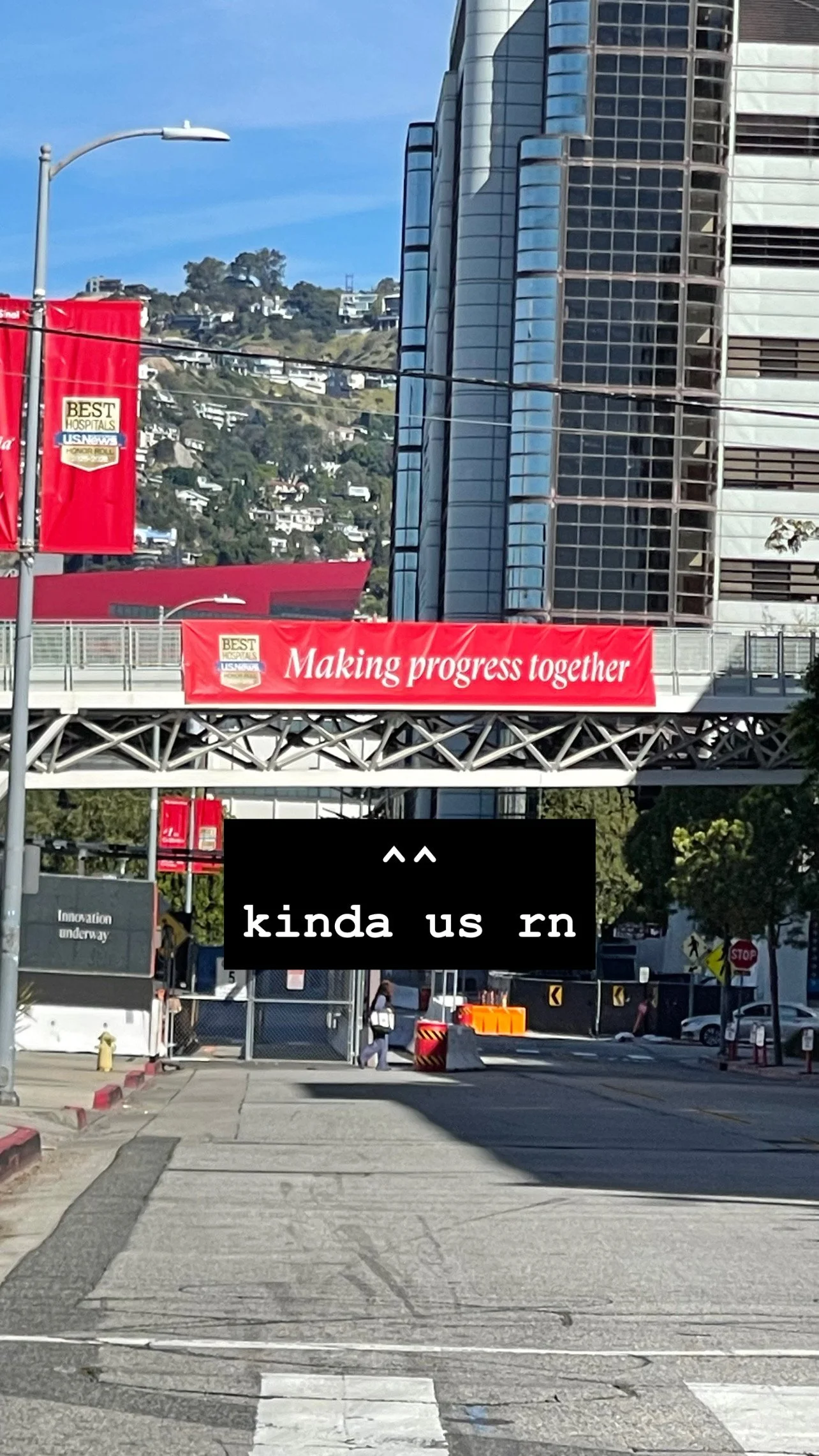 Photo of a 'Best Hospitals — Making progress together' banner over a street. Caption: ^^ kinda us rn.
