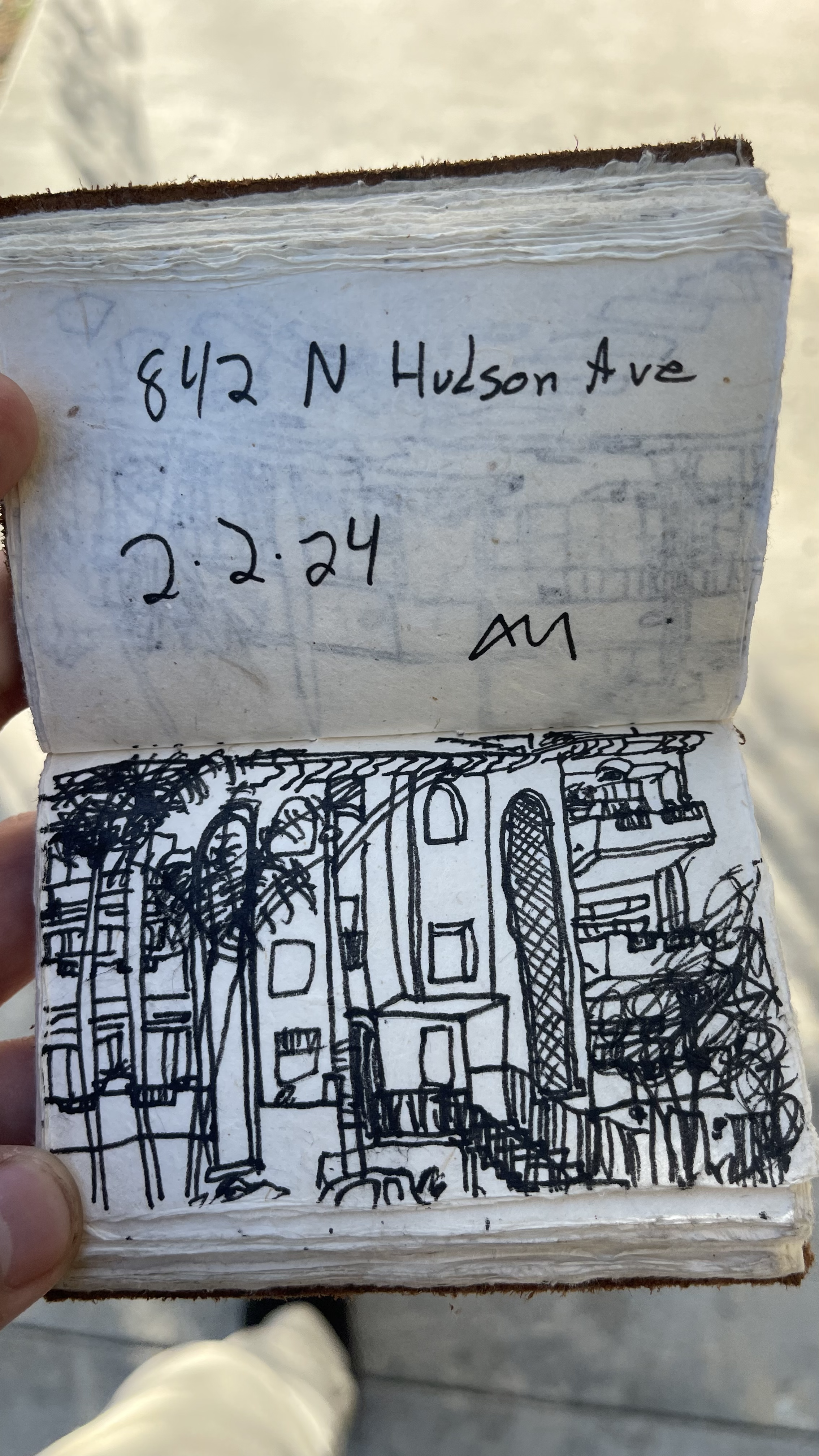 Pen sketch in a handmade notebook of a building at 842 N Hudson Ave, dated 2.2.24.