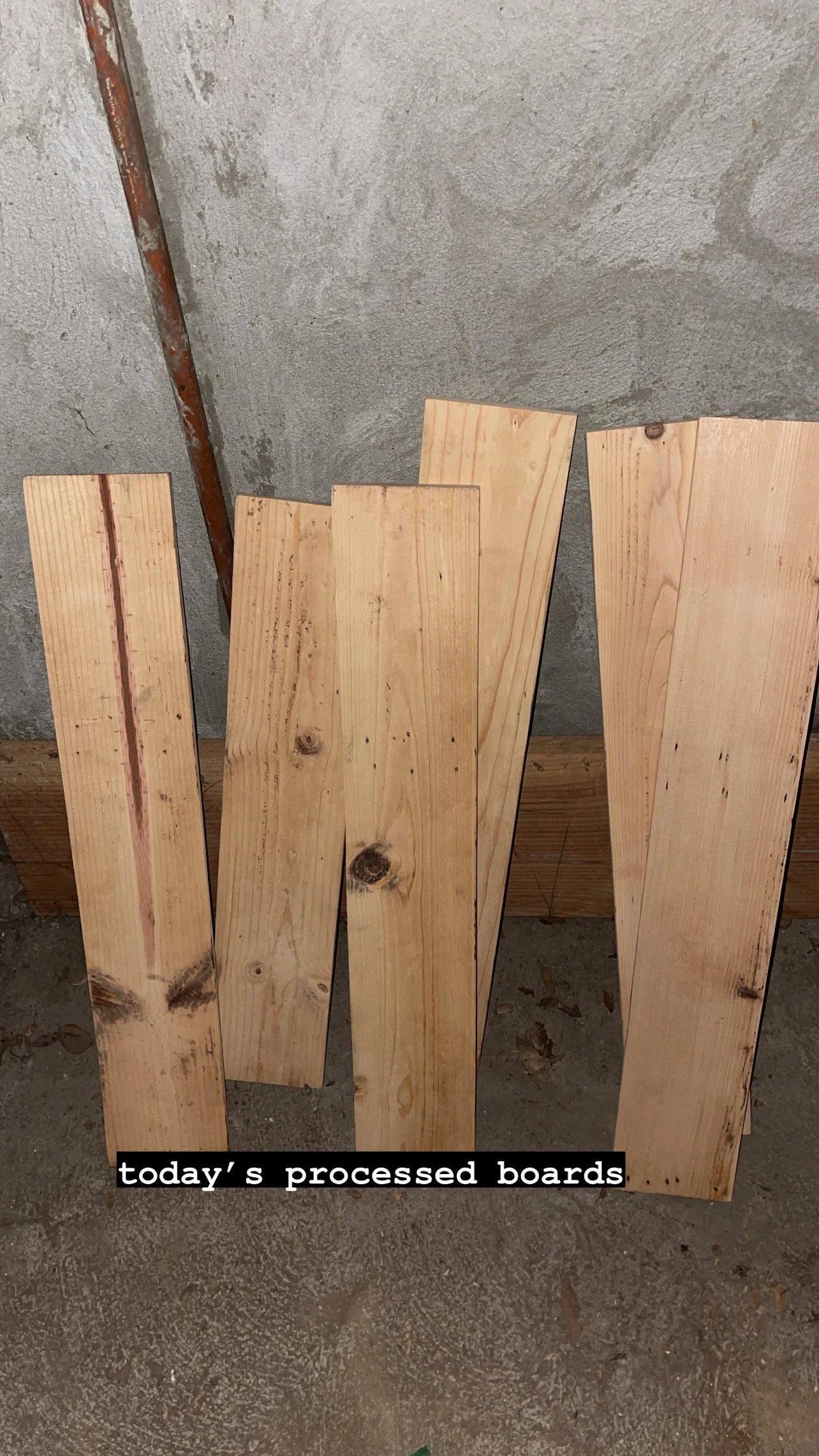 Five processed wood planks, planed and sanded smooth, leaning against a concrete wall, labeled 'today's processed boards'.