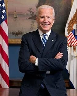 Running character sprite: official portrait photo of Joe Biden, arms crossed.